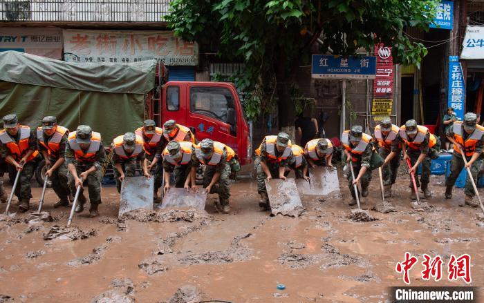 7月4日，萬州區(qū)五橋街道，武警官兵清理街道上的淤泥?！∪矫宪?攝
