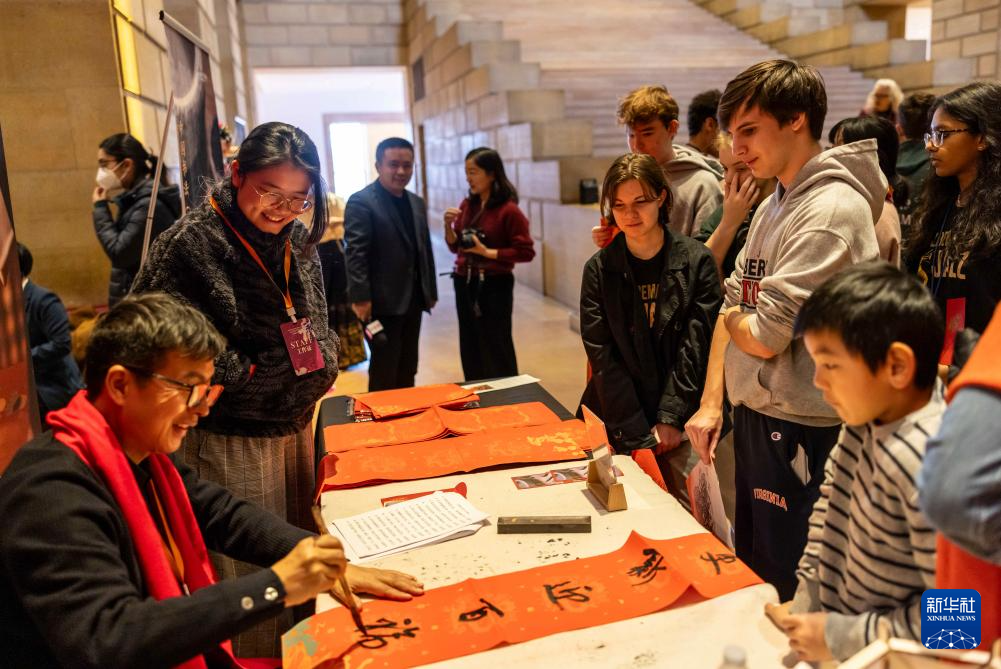 2月11日，書法家在美國費(fèi)城藝術(shù)博物館舉行的龍年迎新春活動(dòng)上為參觀者書寫對(duì)聯(lián)。新華社發(fā)（周煥新攝）