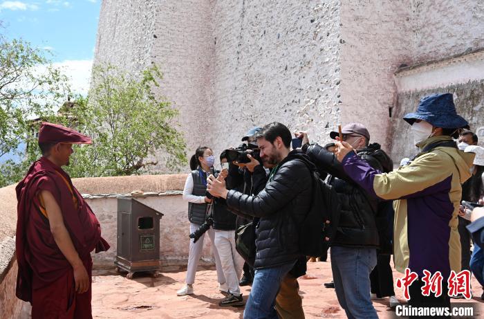 圖為中外媒體拍攝朝拜布達(dá)拉宮的僧人?！≮w朗 攝