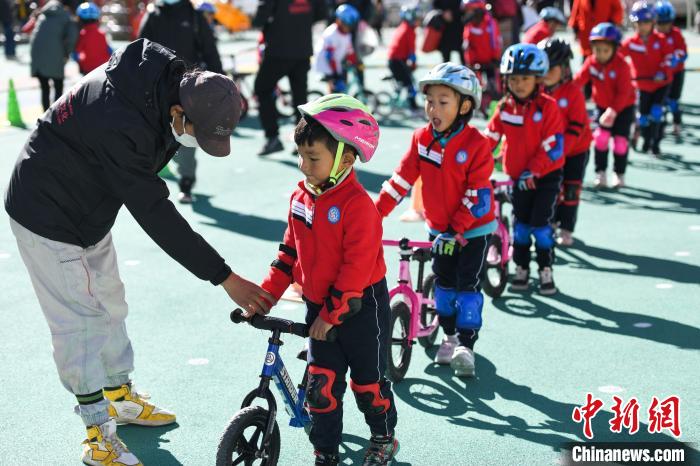 圖為拉薩市實驗幼兒園孩子們在教練的指導(dǎo)下練習(xí)滑步車。　何蓬磊 攝