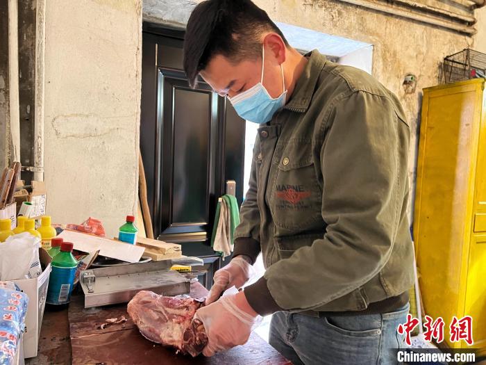 圖為雪豹“奶爸”史壽軍正在準(zhǔn)備投喂雪豹的食材?！●R銘言 攝