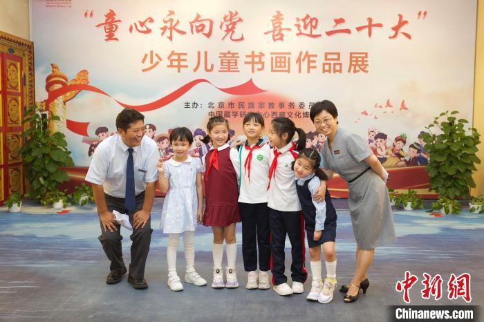 圖為與會嘉賓與入選畫作的“小作者”們在展覽上合影。　中國藏學(xué)研究中心供圖