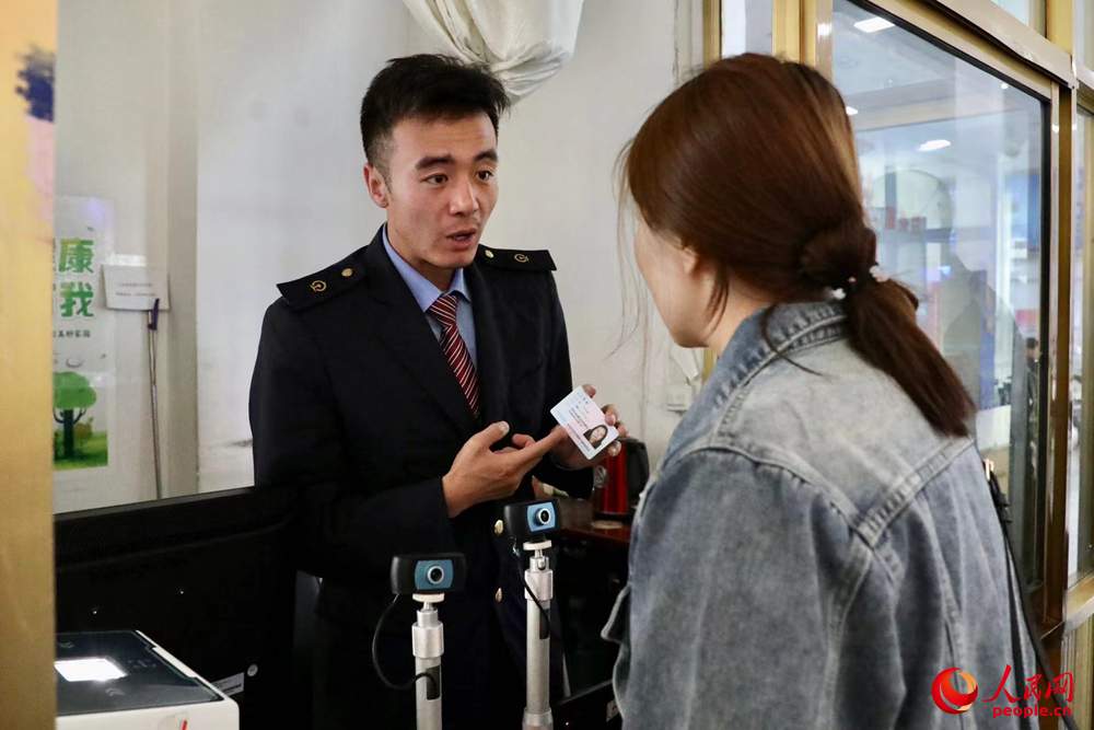 車站工作人員向旅客解答疑問(wèn)。人民網(wǎng)記者 次仁羅布攝